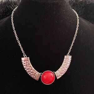 Silver necklace with a red eye